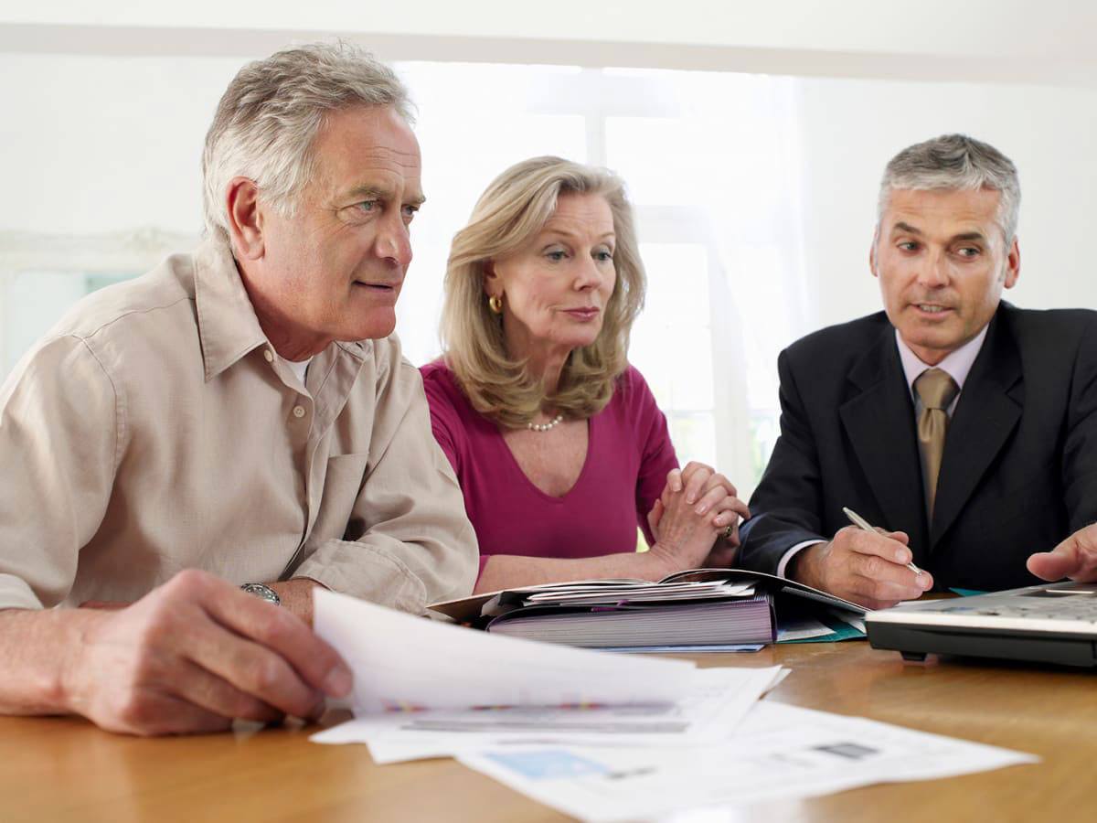 A senior couple consulting with their retirement advisor how to make the best retirement strategy | Outlook Wealth Advisors