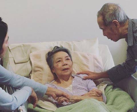 A family came to visit an Asian woman lying in a hospital bed | Outlook Wealth Advisors