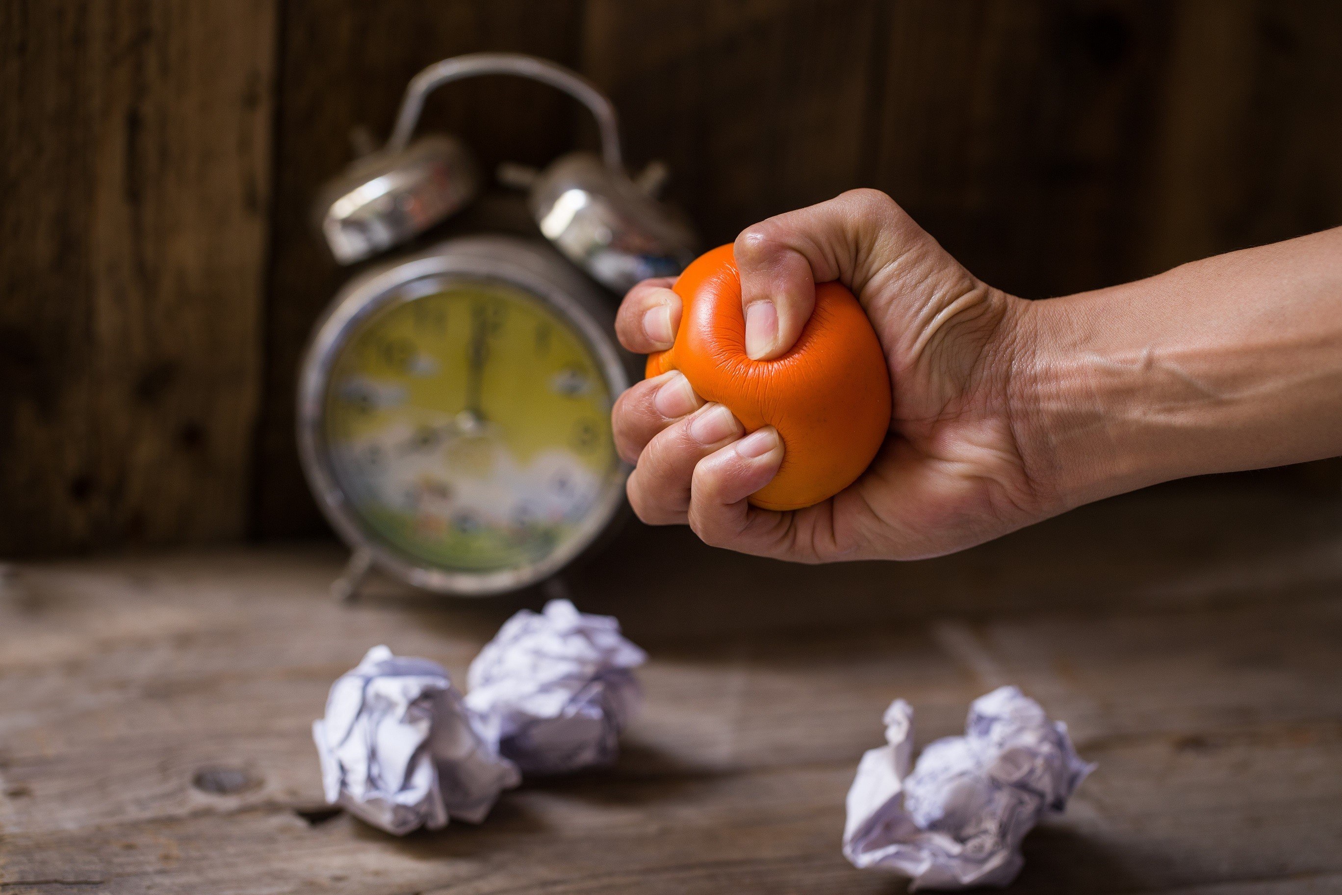 A person squeezing stress ball for stress relief because she can't make sustainable retirement strategy | Outlook Wealth Advisors