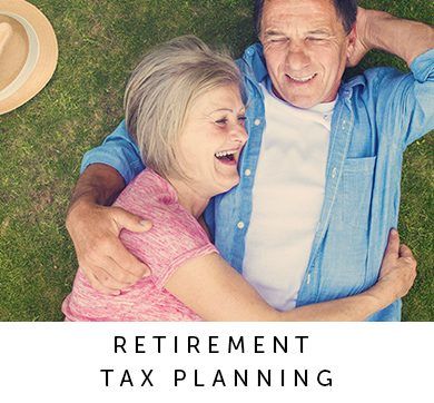 An Older couple feeling relaxed while lying on the lawn because Outlook Wealth Advisors helped them with retirement tax planning.