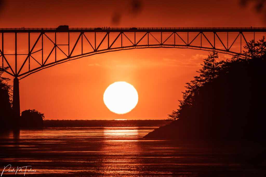 Ocean sunset under bridge